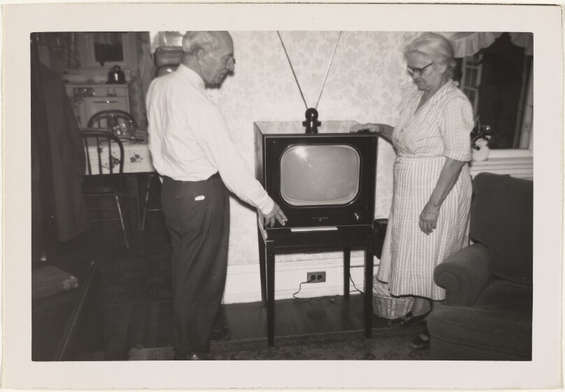 [Man and woman with Sylvania television set]