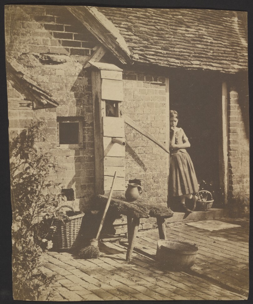 [Girl in farmhouse doorway]
