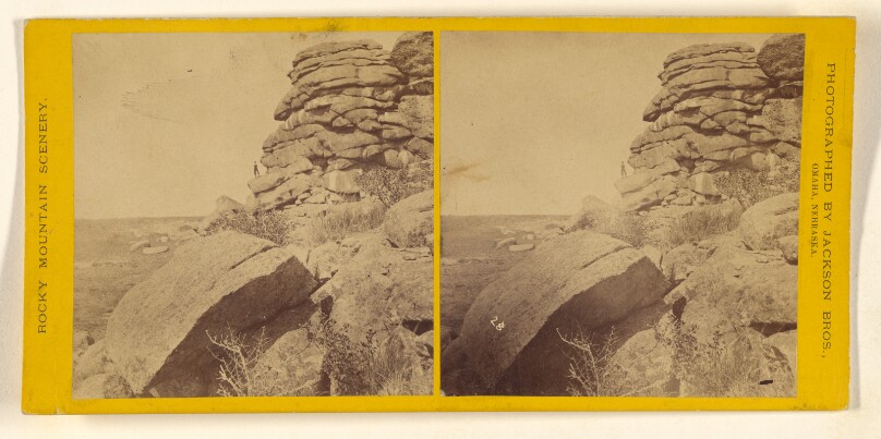 [Rock formation, man standing at bottom in far background]