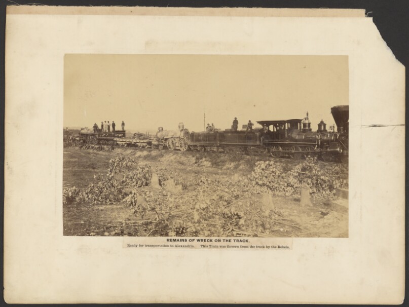 Remains of Wreck on Track, Ready for transportation to Alexandria. This Train was thrown from the track by Rebels.
