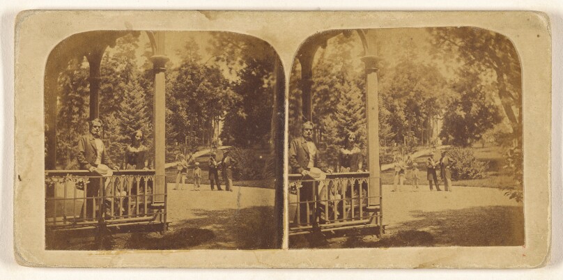 [Man and woman posed on porch, group of four outside on lawn]