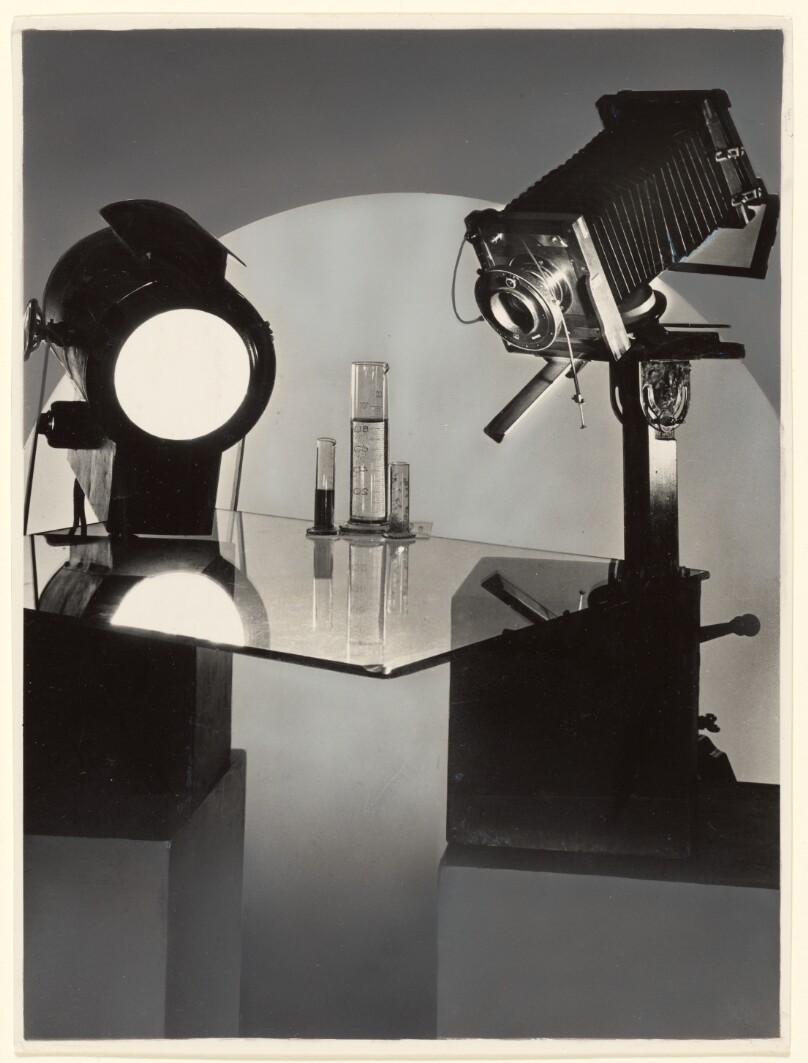 [Studio Set-up with Camera, Light, Glass Table & Arrangement of Glass Beakers]
