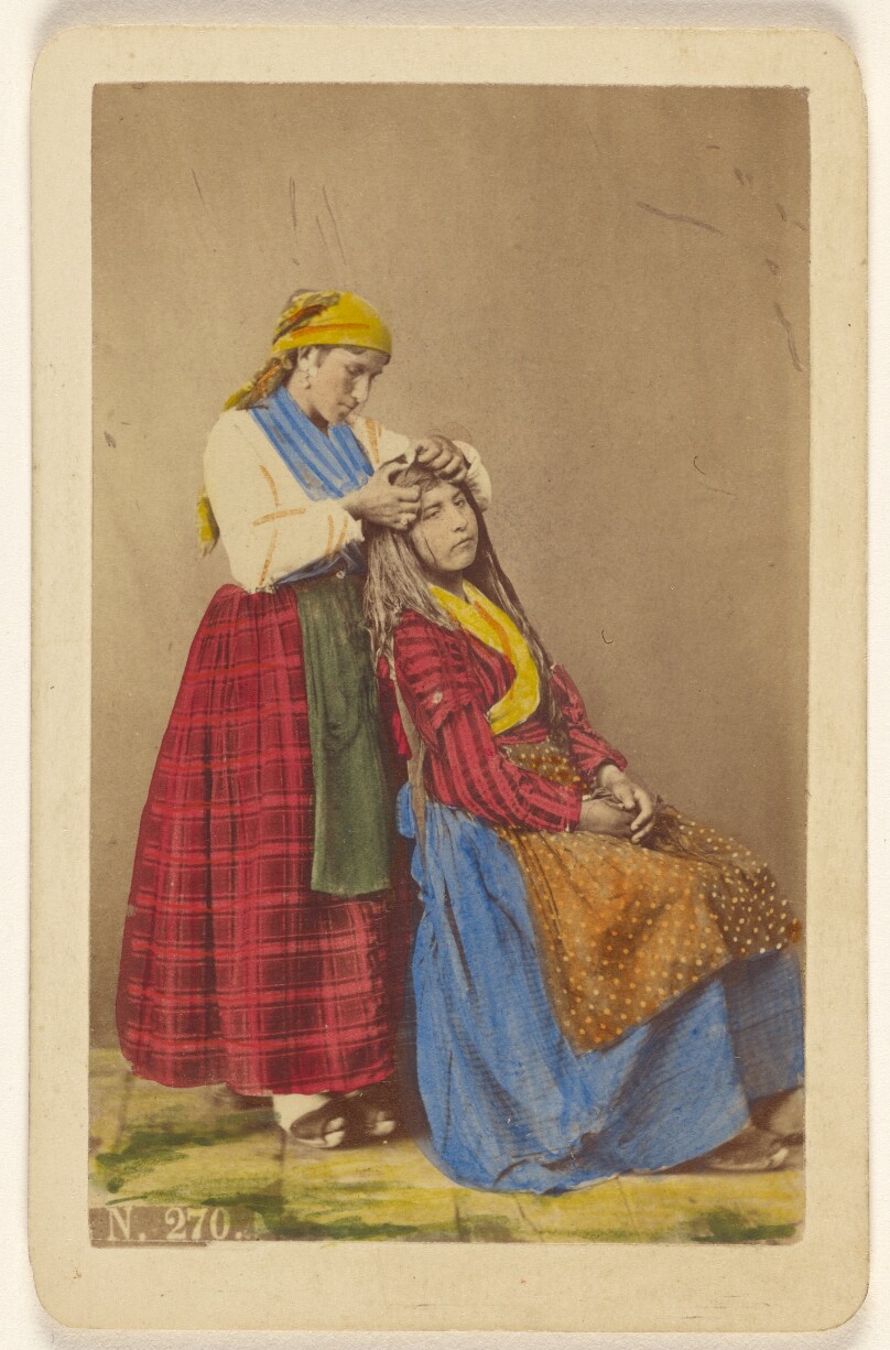 [Older woman doing the hair of a younger woman].
