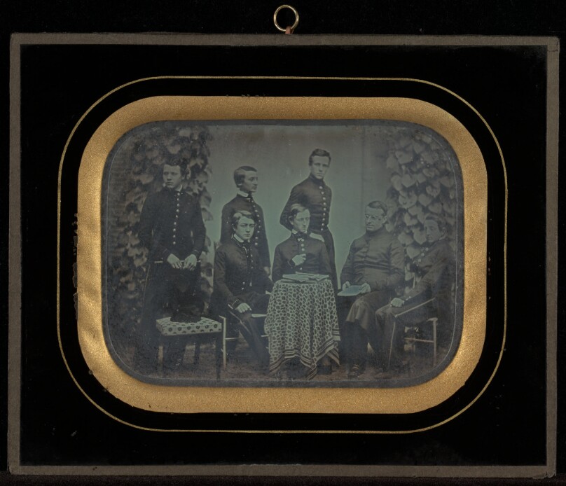 [Portrait of six boys in military school uniforms with their teacher]