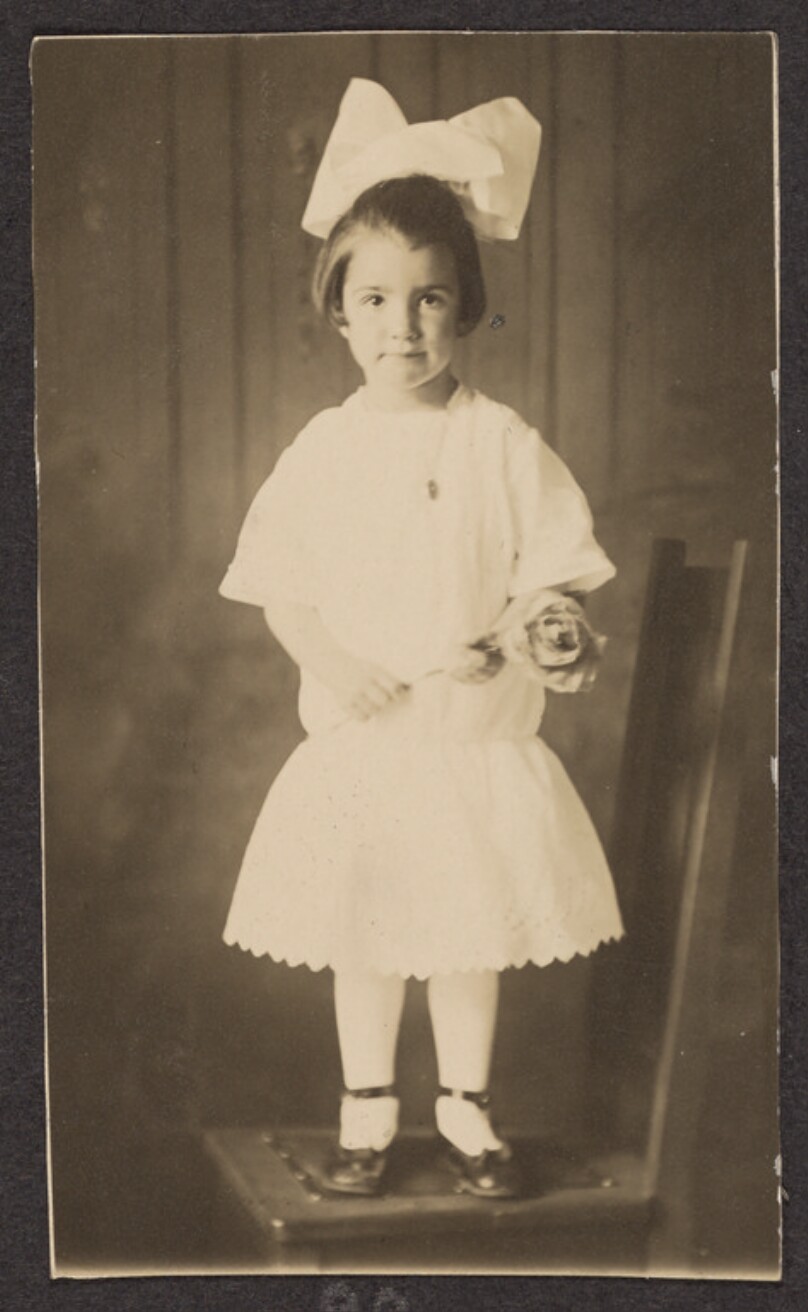 [Portrait of a young girl with a flower]