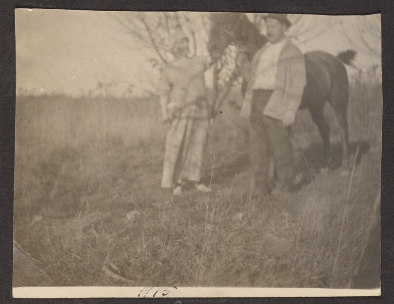 [Man and woman pose with a horse]