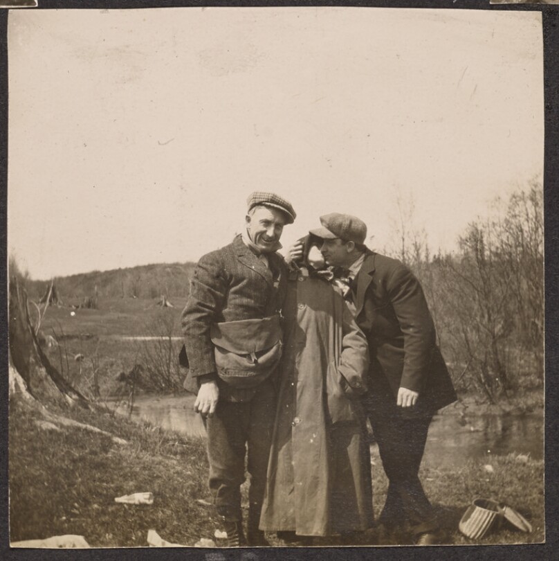 [Group portrait in front of a pond]