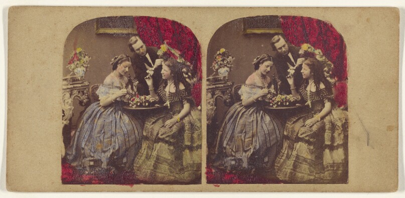 [Parlor scene: woman seated at table, man standing at center]
