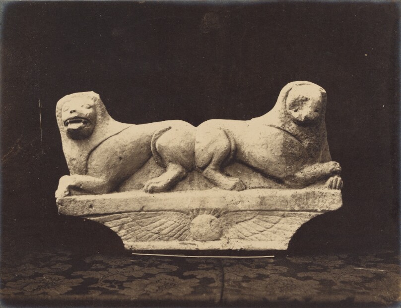 Greco-Egyptian architectural fragment: two lions recumbent above a winged globe.