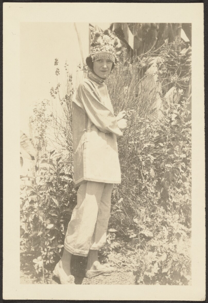 [Woman in Costume Standing in Garden]