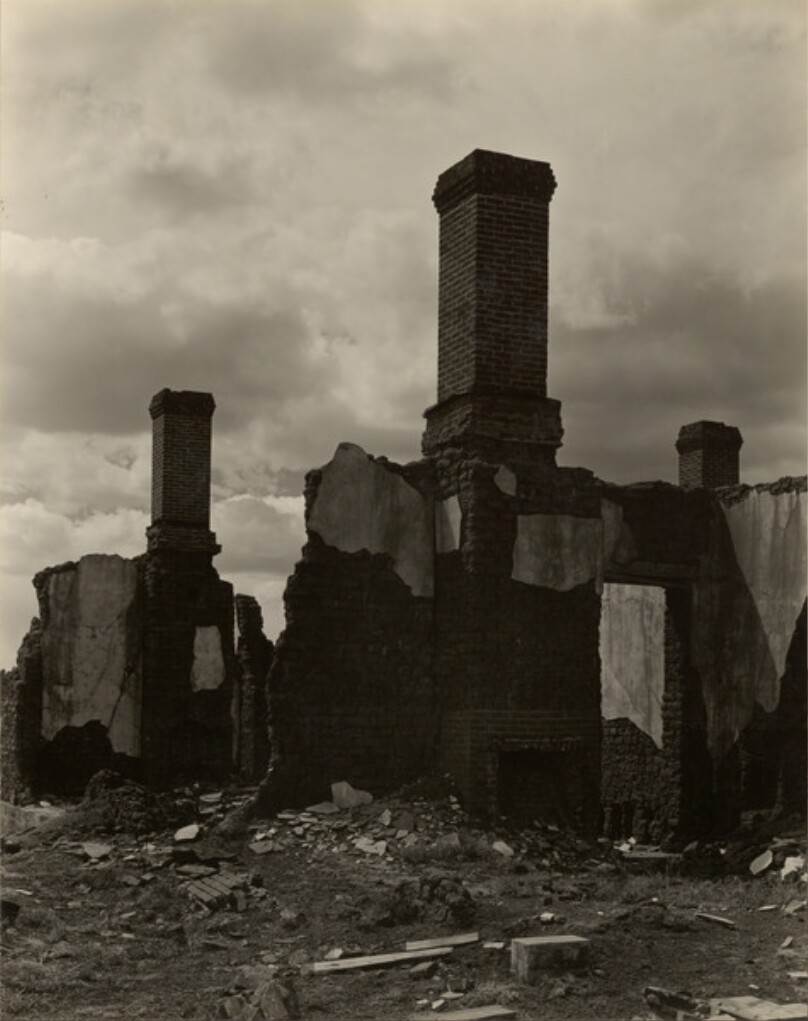 [Ruins of Brick Buildings with Three Chimneys Standing]
