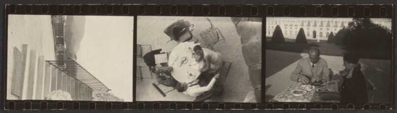 [Contact print-strip from three 37mm negatives: steps/table with three people from above and couple seated at table with castle (?) in background]