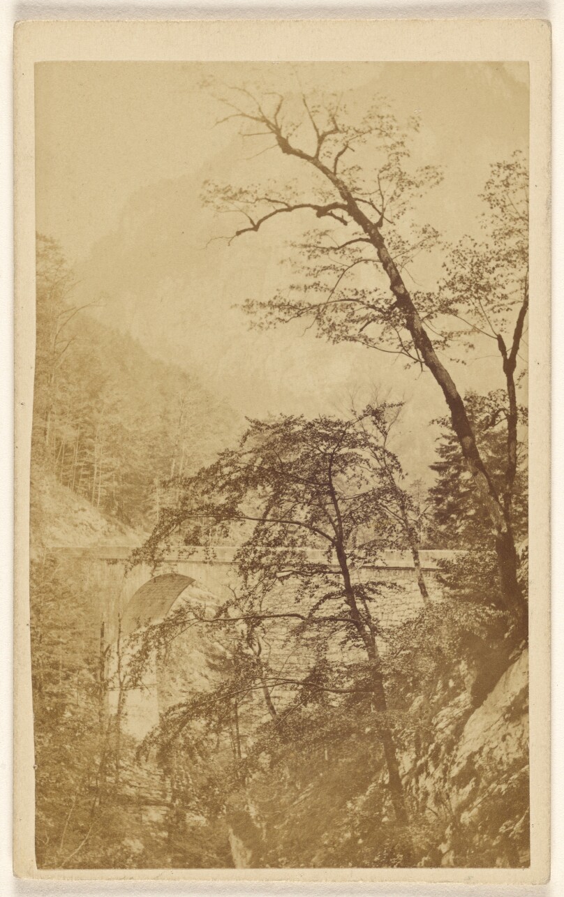 [Unidentified view with bridge, trees, and mountain, perhaps at Uriage-les-Baines, France]