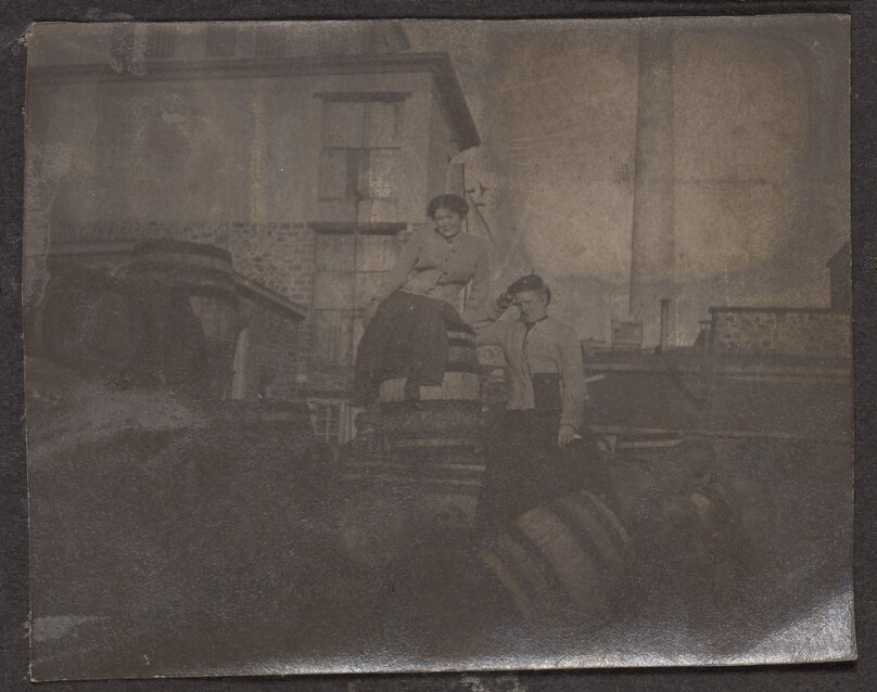[Two women outside factory]
