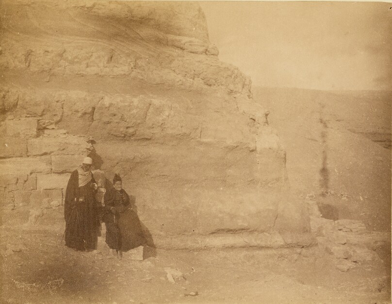 [Two men at base of ruins]