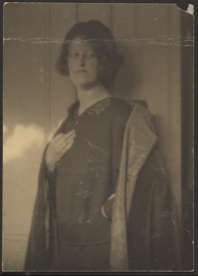 [Clare Shepard Standing Against Wall]