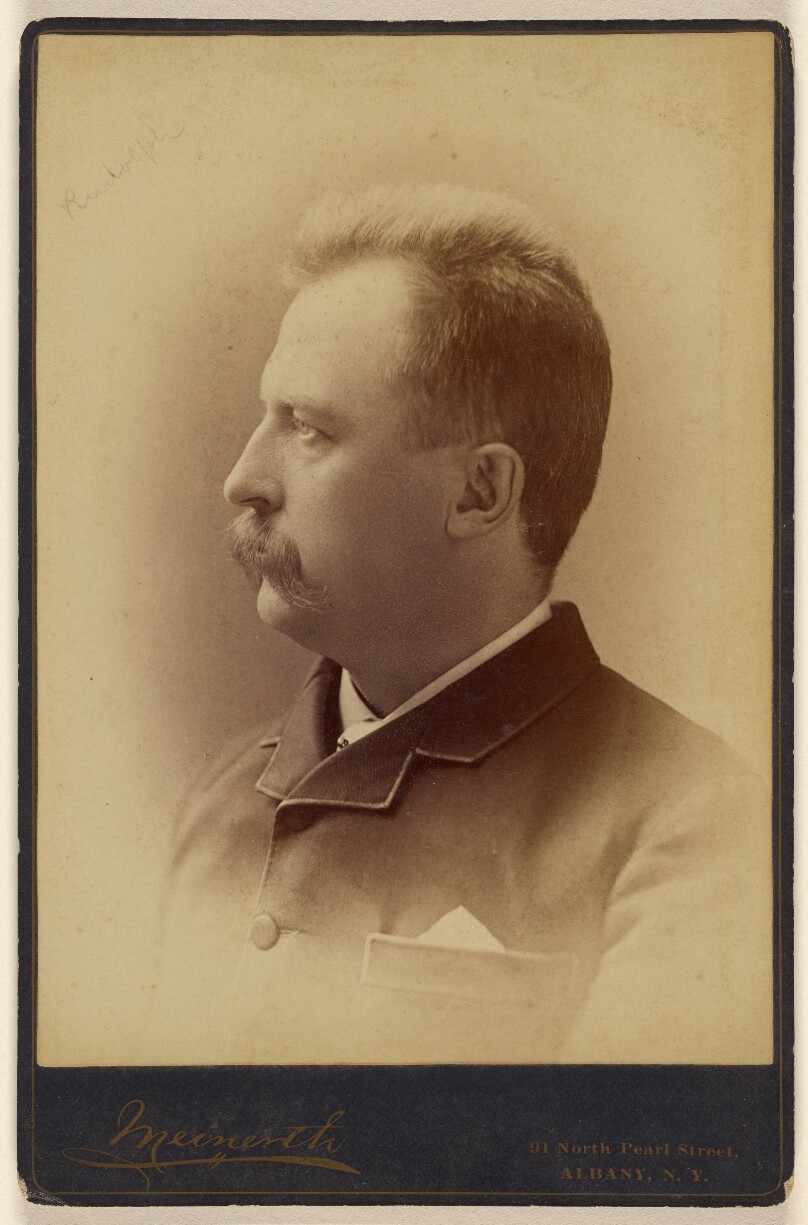[Unidentified man with short-cropped hair and a moustache, in profile]