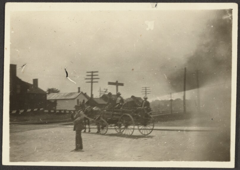 [Wagon stopped at railroad crossing]