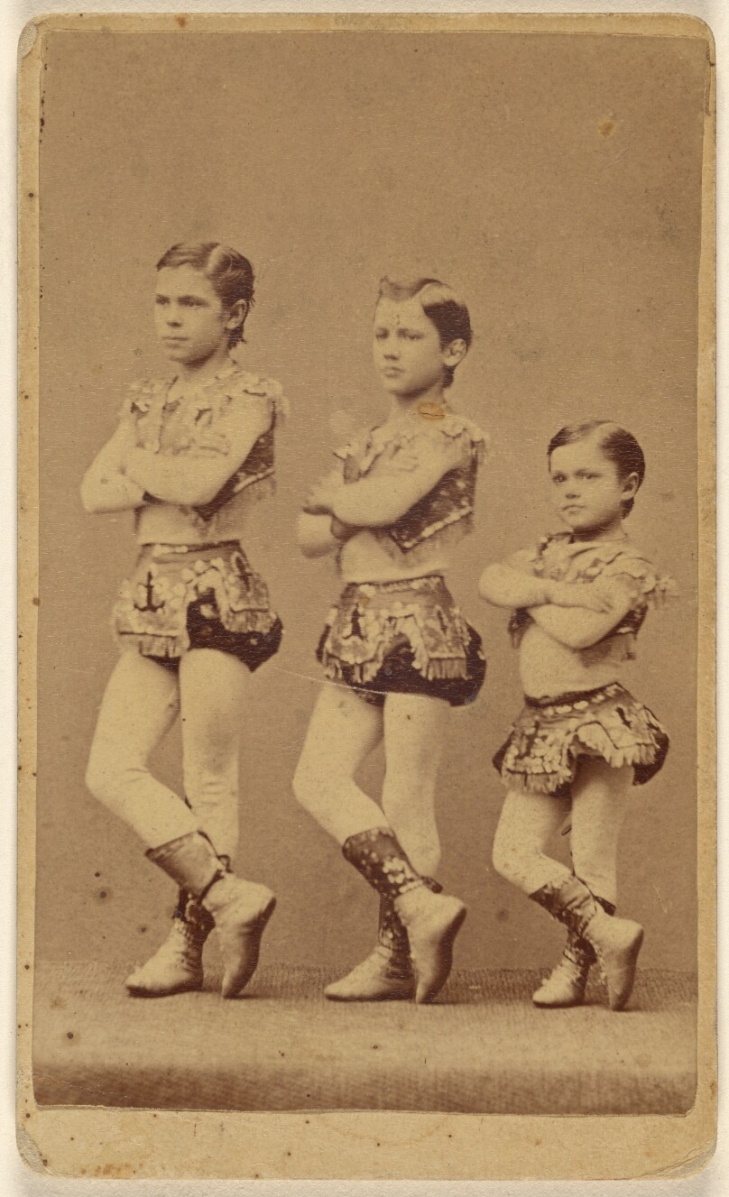[Three young male dancers or circus performers]