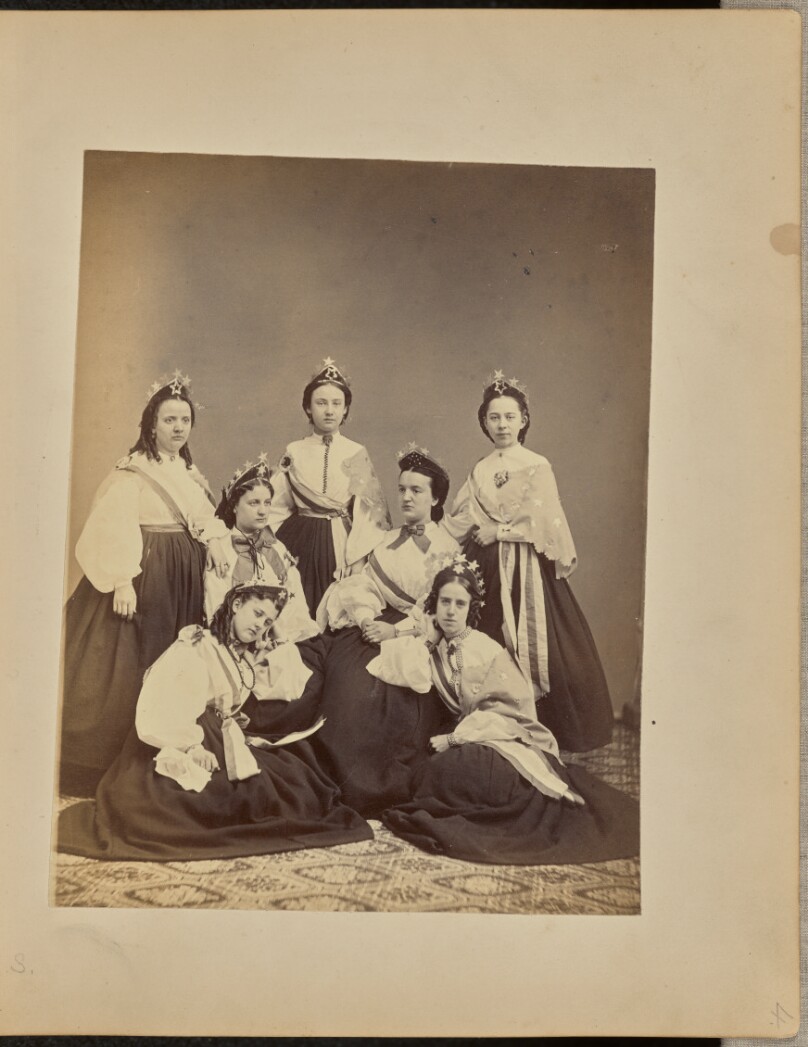 [Group portrait of women in crowns and sashes]