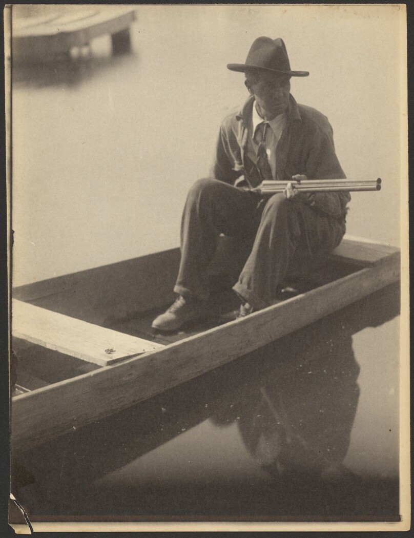 [Black Man in Flat Boat, Holding Shotgun]