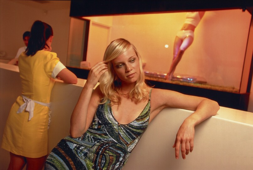 Actress Amy Smart, 24, models Versace at the Standard Hotel, where a live mannequin lounges in a glass box in the lobby, Los Angeles, California