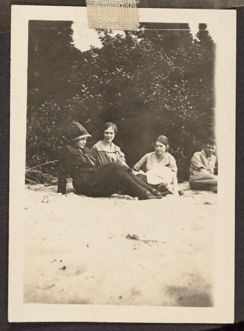 [Group sitting on a beach]