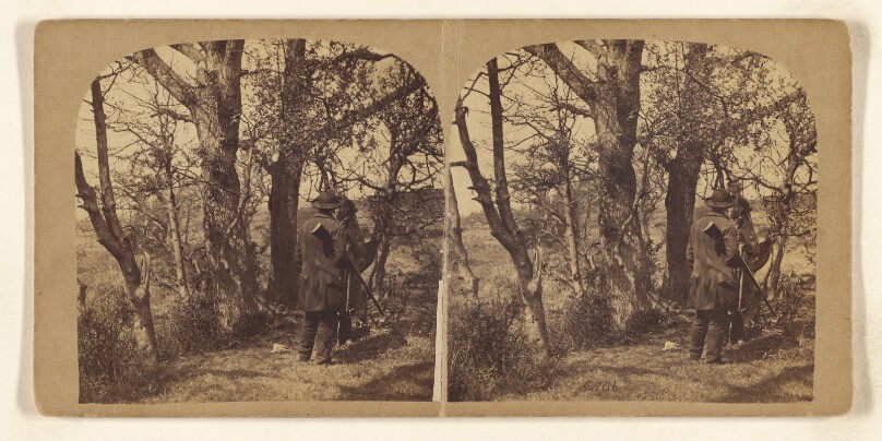 [Forest scene: two men standing, talking, one carrying a shotgun]