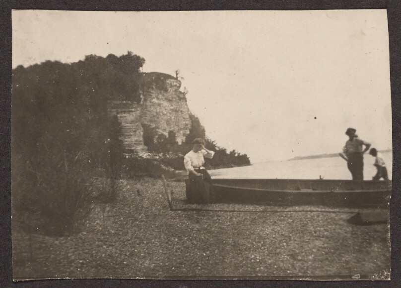 [Woman sitting on a canoe]