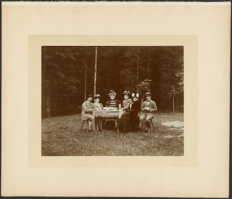 [Group with Mr. and Mme. Adolphe Salles, seated outdoors at table]