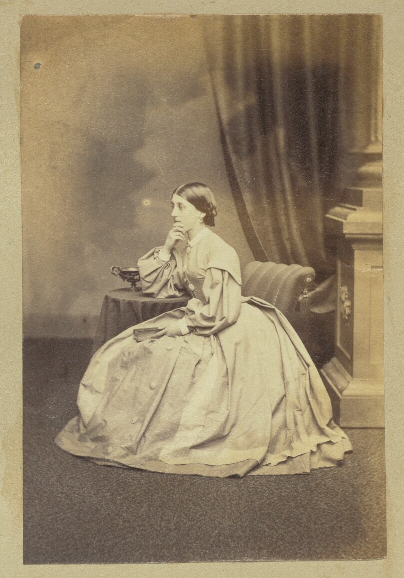 [Portrait of pensive woman holding book]