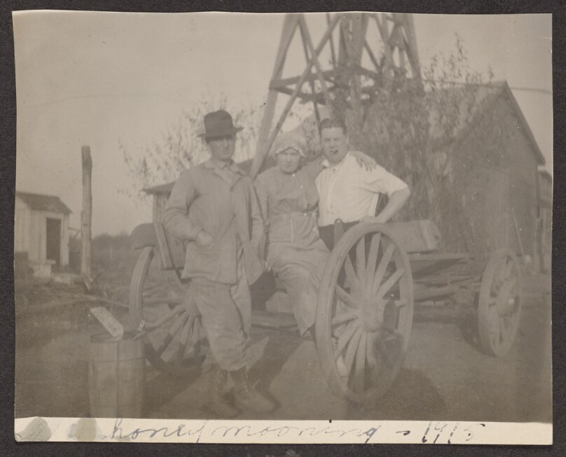 [Group posing with a cart]