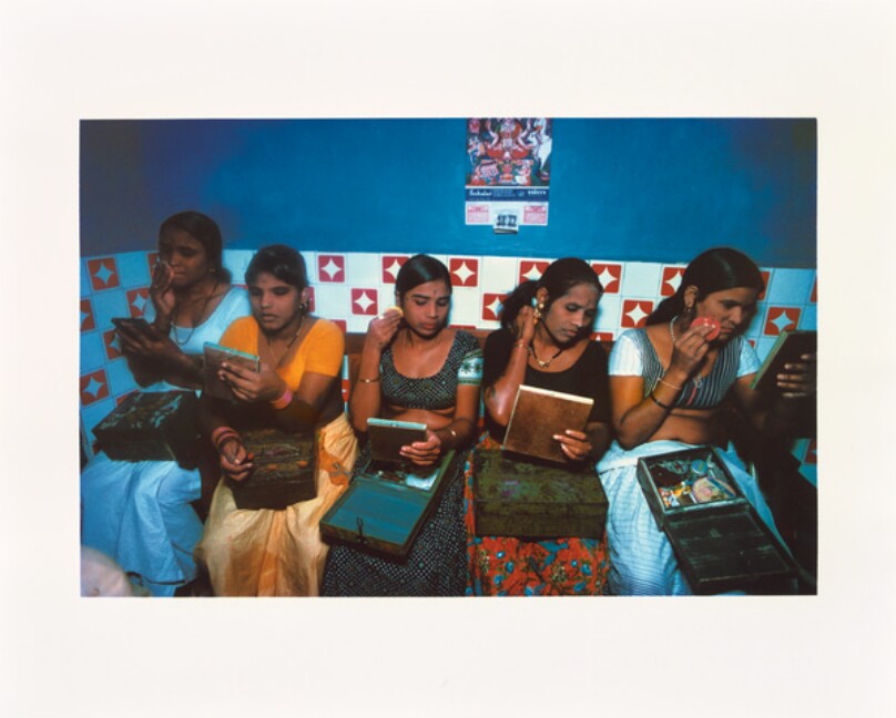 Five girls with their make-up boxes prepare for the evening.