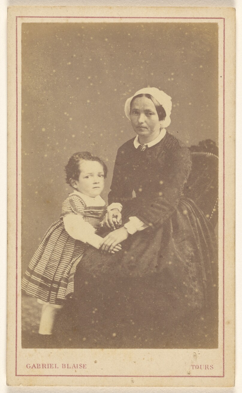 [Unidentified woman seated, with a little girl standing next to her]
