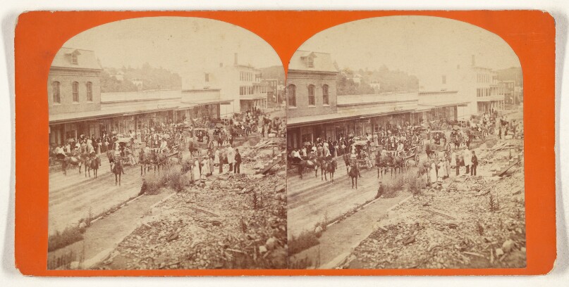 [Street scene crowded with people and horse-drawn wagons and carriages, possibly at Wilton, New Hampshire]