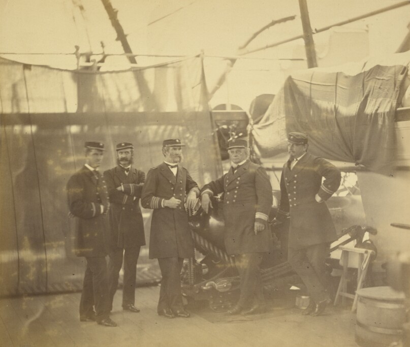 [Five officers aboard a ship]