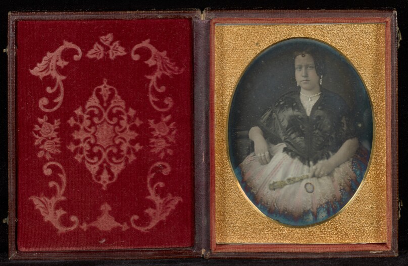 [Portrait of a Woman in a Black Jacket Holding a Fan]