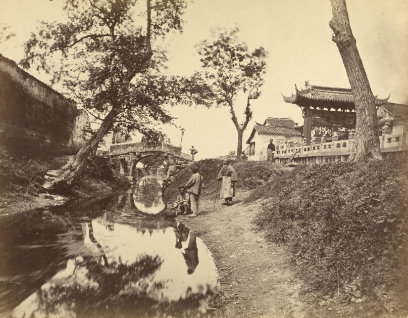 [Chinese view of a river and a bridge in a village including several Chinese people]