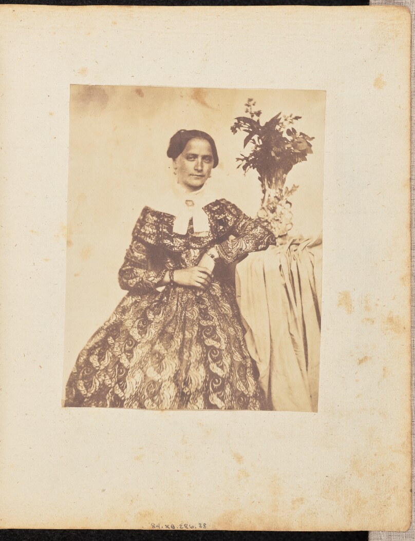 [Portrait of a woman in a patterned dress]