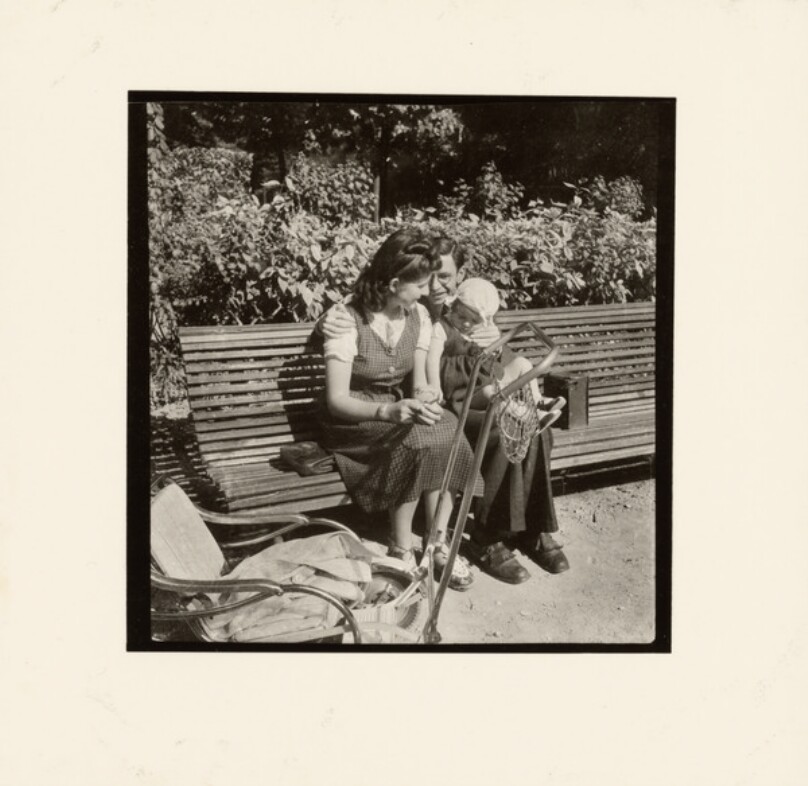 [Couple and baby on park bench]