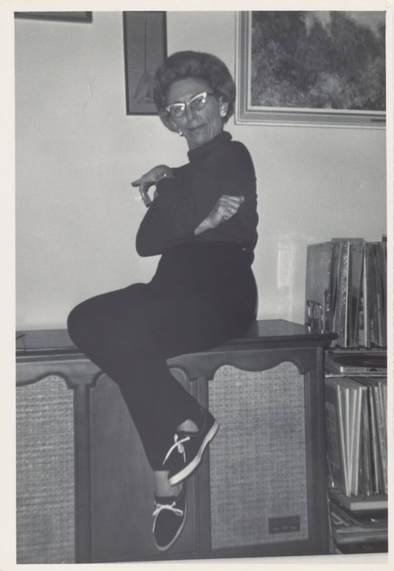 [Woman sitting on speaker cabinet]