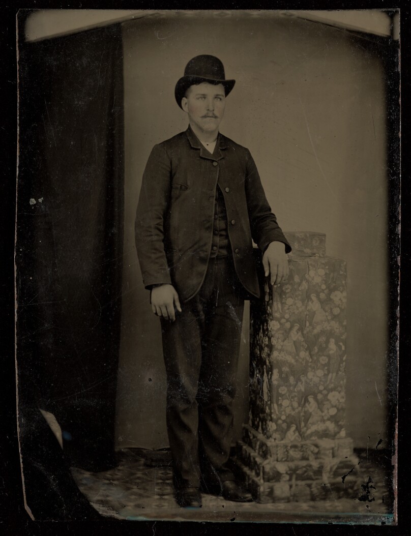 [Unidentified man with moustache wearing a derby, standing]
