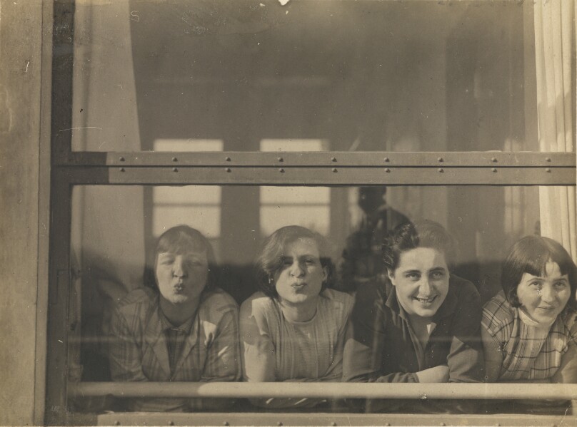 [Four Women Looking Through Window]