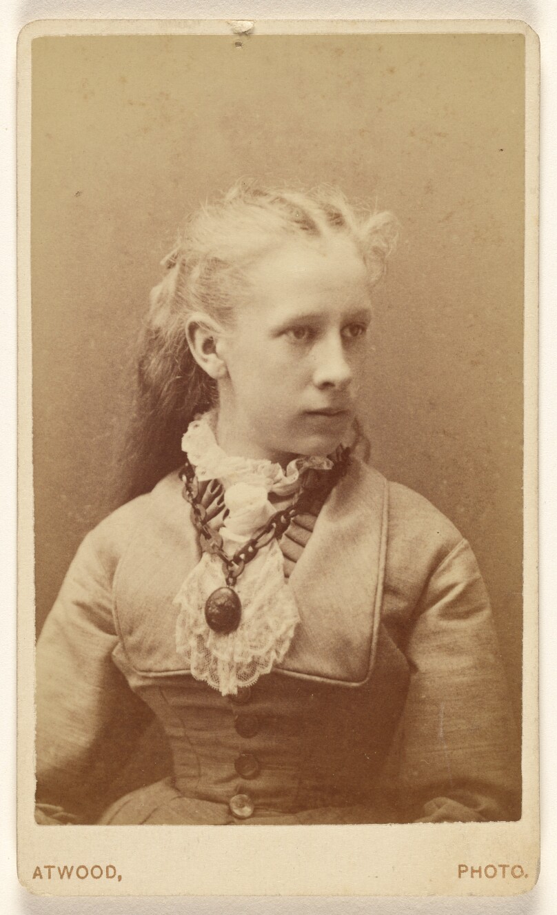 [Unidentified young woman seated, in 3/4 profile]