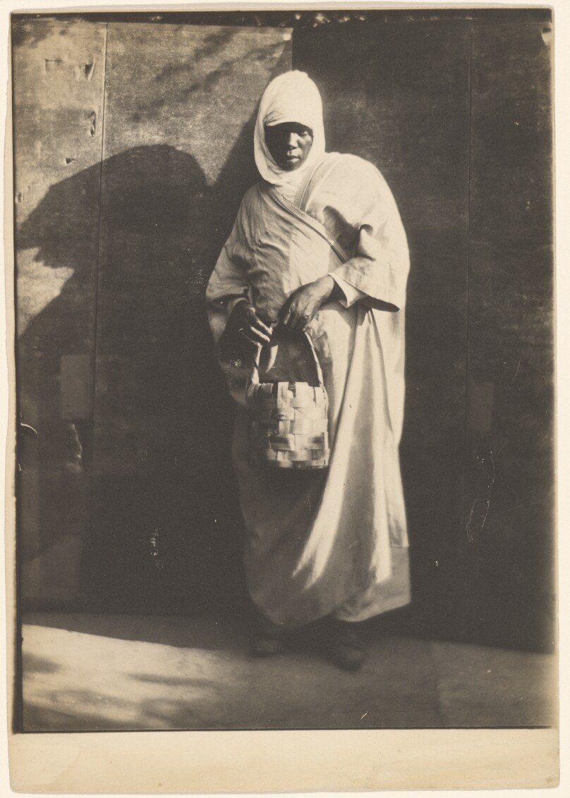 [North African portrait study/Black man standing with a basket]