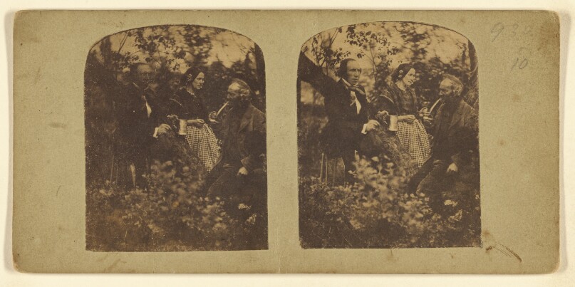 [Two men and a woman in a wooded area, one man is holding a pewter mug, the other man is smoking a long-stemmed pipe]