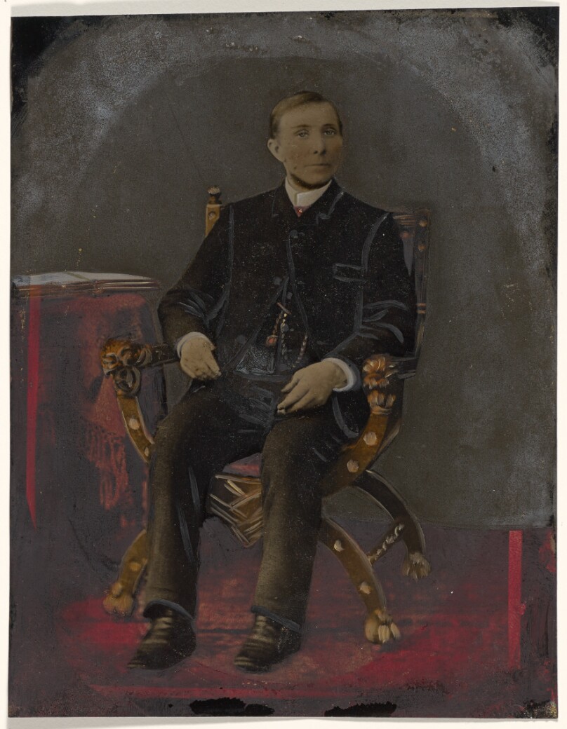 [Portrait of seated man]