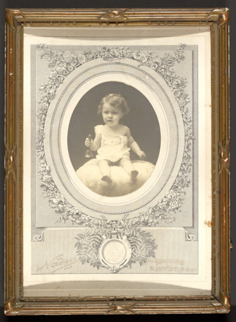 [Child Holding a Bell]