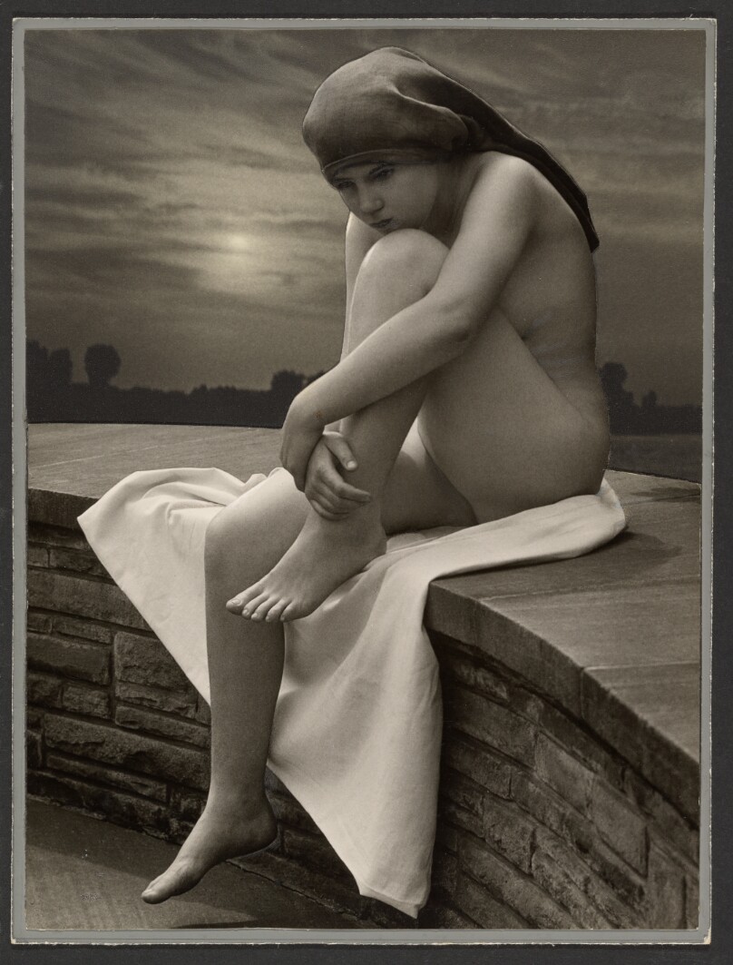 [Female nude seated on ledge]