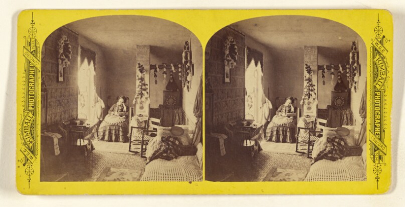 [Woman seated in chair with book on lap, hand to face, sleeping]